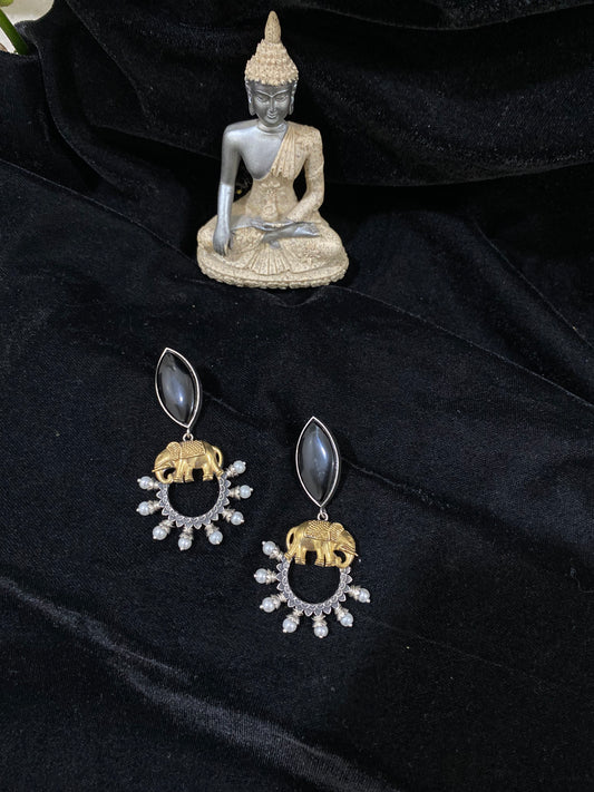 Elephant holding a black stone