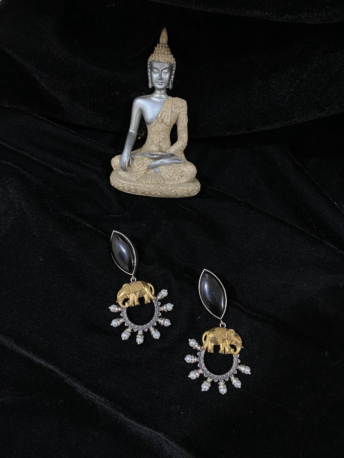 Elephant holding a black stone